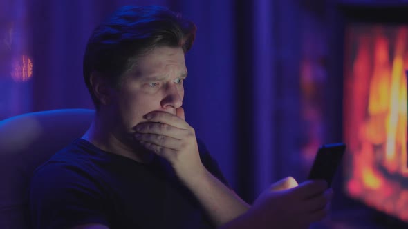 Unpleasant Surprise of a Man with a Phone at Home alt
