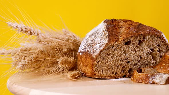Freshly Baked Bread in Rustic Setting on Yellow Background