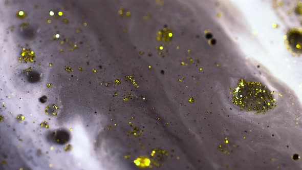 Macro Close Up Shot Of Golden Wet Glitter. Golden Space Glittering Particle Background.  alt