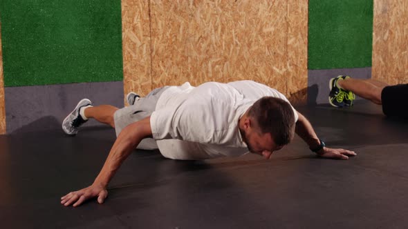 Fulllength Shot Groups Athletes Engaged in Sport Looking Away Doing Pushups alt