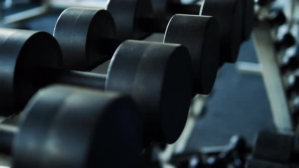 Footage Of Metal Dumbbells On A Rack. Classic Dumbbells In The Gym.