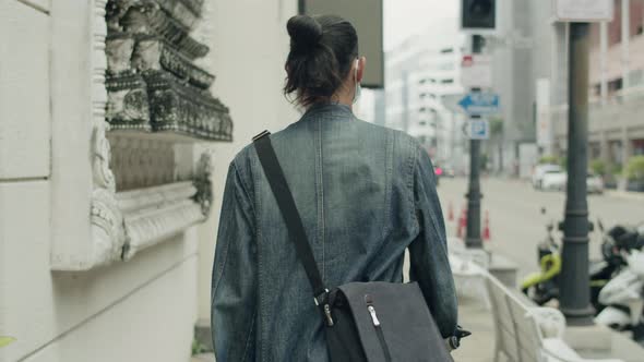 Asian man walking on the street in the modern city.