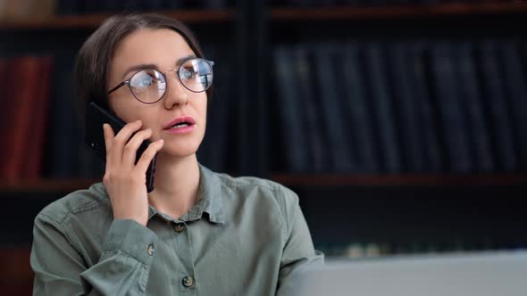 Business Woman Talking Smartphone Working Laptop Discussing Project Partner at Library Room Closeup