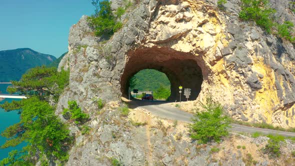 Aerial View on Tourists with Car in Mountain Tunnel at Piva Lake in National Park Dormitor of alt