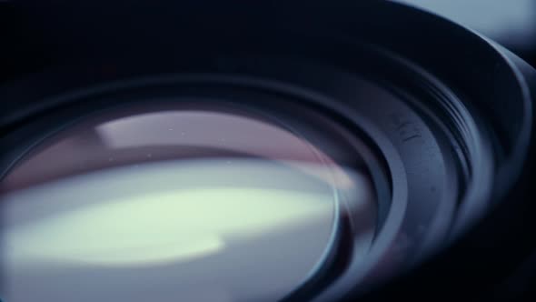the lens of a movie camera or photo camera is shot in close-up alt