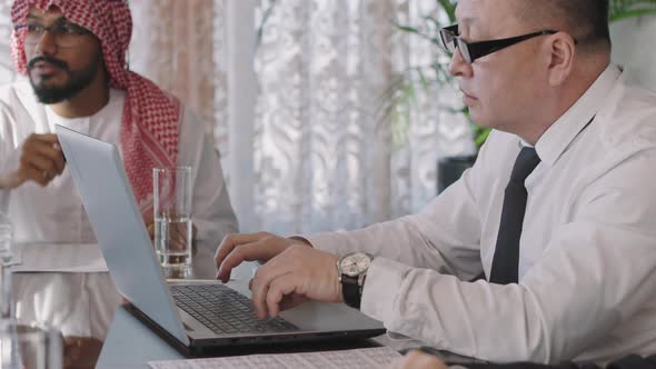 Multi-Ethnic Business Men Working On New Project alt