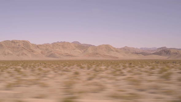 View of Nevada Desert From Car on Clear Day Road Trip