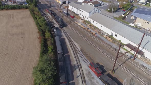 Multiple Antique Restored Steam Engines in a Train Yard Steaming Up Blowing Smoke alt