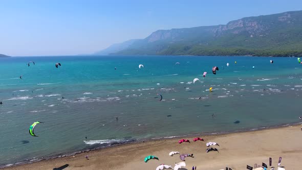 Kiteboarding, Kitesurfing Kiters and Kiteboarders are Pulled Across Sea Water by a Wind Power Kite alt