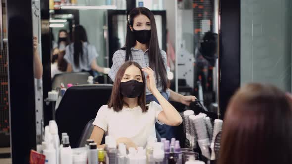 Hairstylist in Mask Takes Off Cape From Client After Haircut