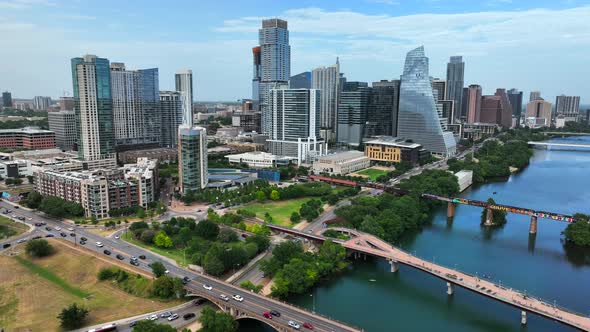 Austin Texas cityscape skyline panorama. Aerial pullback reveals bridges over Colorado River. alt