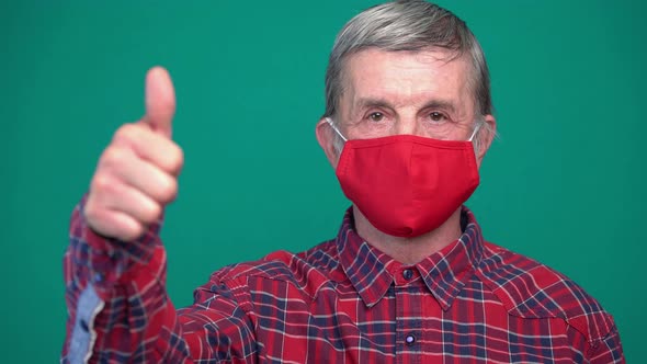 Old Man Show Thumb Up and Wear Red Medical Mask