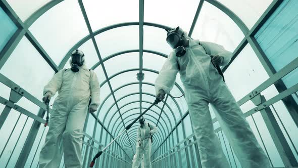 Chemical Treatment of a Pedestrian Overpass Done By Experts. Covid-19, Coronavirus Pandemic alt