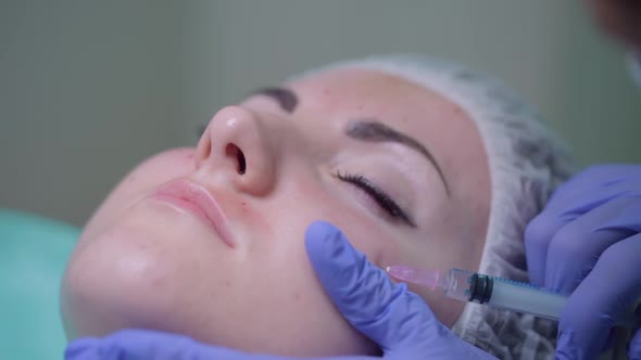 The Beautician Makes a Treatment Procedure to the Patient