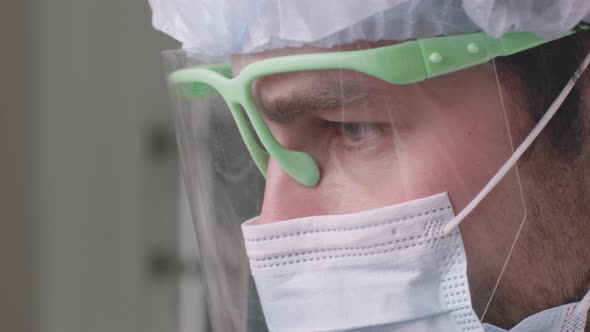 Close Up Portrait of Doctor Dentist Wearing Protective Face Mask and Screen Treating Teeth of alt