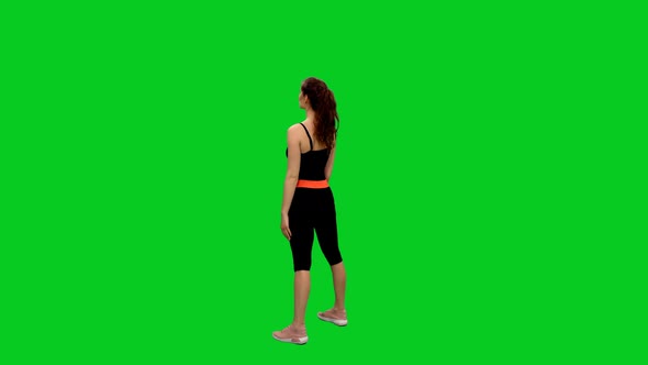 Young Slender Woman Practicing Squats on Green Screen