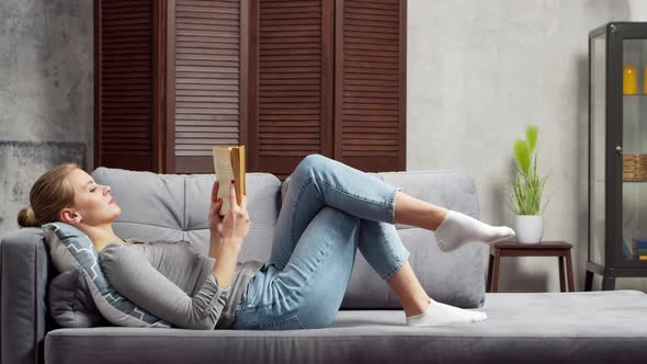 Young woman works with documents using a laptop at home. alt
