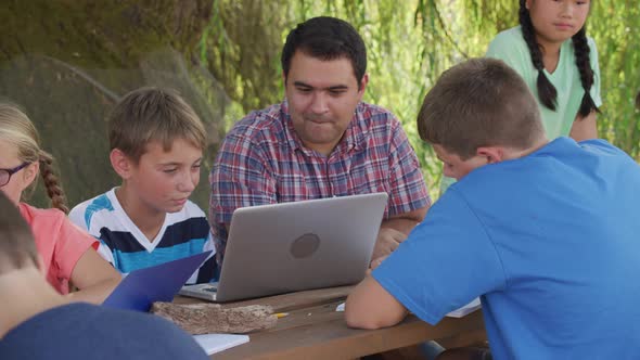 Kids at outdoor school using laptop computer
