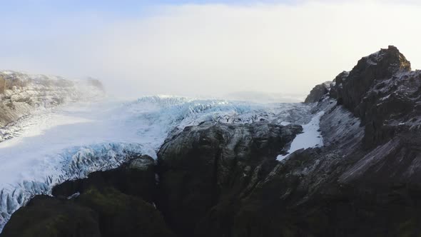 Drone Towards Black Mountain Side And Frozen Glacier Of Vatnajokull alt