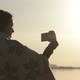 Beautiful Girl Standing at Dawn, Using Phone and Made Selfie - VideoHive Item for Sale