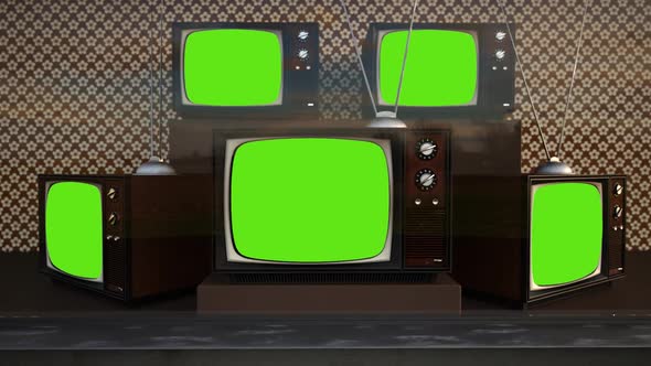 An exhibition of old-fashioned retro color tv sets with tuner antennas.
