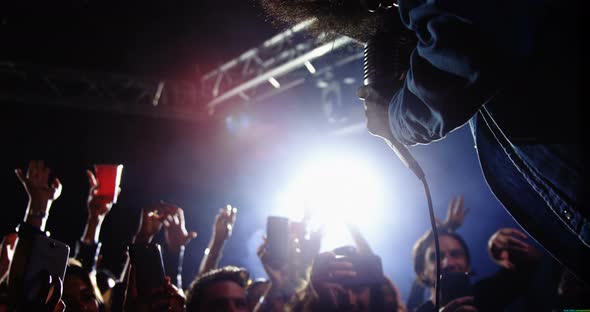 Group of people dancing while singer performing at a concert 4k alt