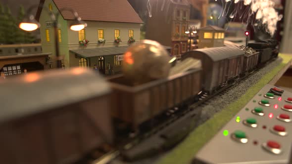Model Train with Steam Going Through Railway Station. alt