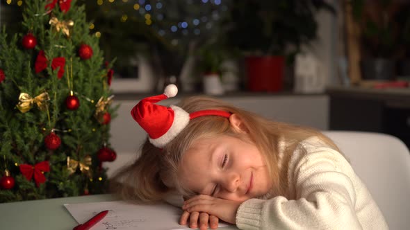 a Little Blonde Girl Writes a Letter to Santa Claus Gifts for Christmas a Happy Child alt