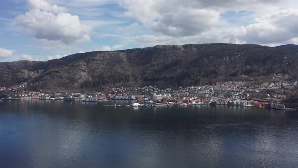 Slow aerial orbit Sandviken with Skuteviksboder and Stoltzekleiven mountain behind - Norway alt