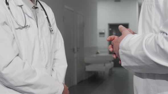 Unrecognizable Doctors Shaking Hands at the Hospital