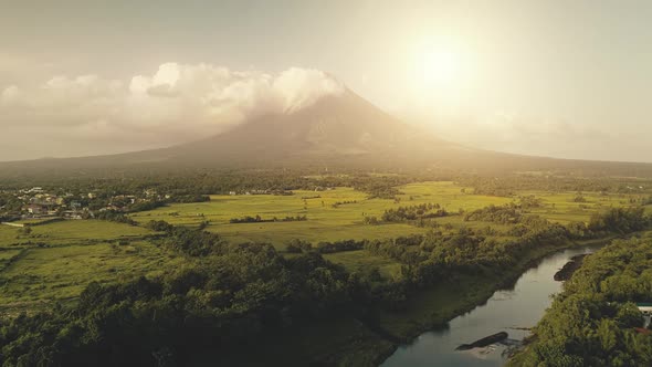 Tropic Sun Shine Over River at Erupt Volcano Aerial
