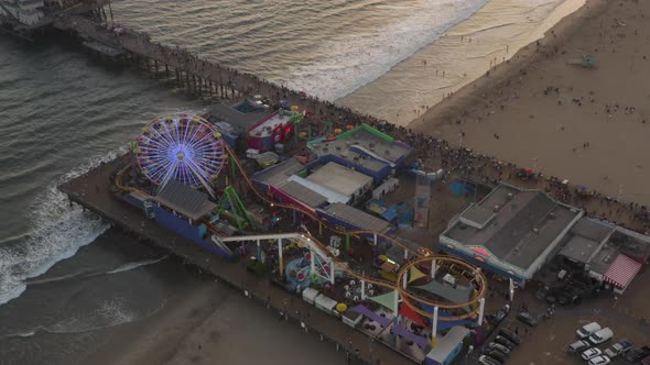 AERIAL Circling Santa Monica Pier Los Angeles From Above at Beautiful Sunset with Tourists alt