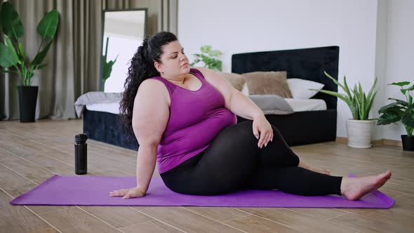 Young Woman Stretches Leg Doing Pilates on Floor Closeup alt