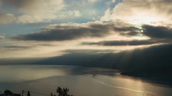 Dramatic and Moody Time Lapse Shot of Sunrise Over Rocky Shore and Calm Sea on Kefalonia Island alt