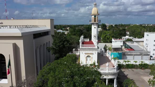 Aerial trucking shot to the right of the el Minaret mansion on the Paseo de Montejo in Merida, Yucat alt