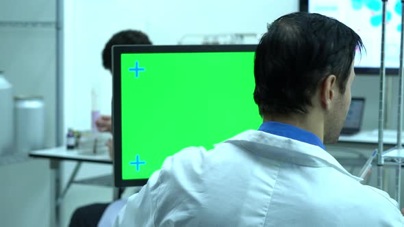 Scientist male with monitor green screen