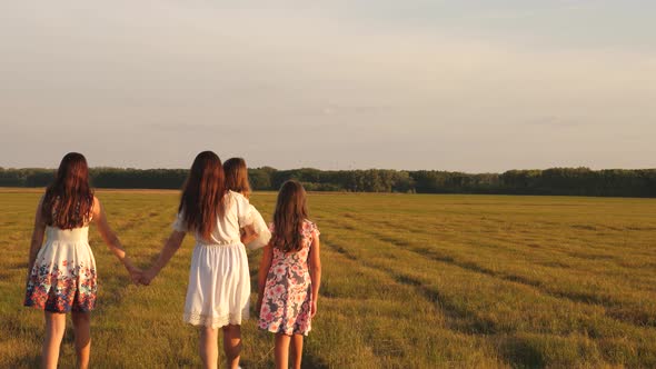 Happy Young Family with a Child Walking on a Summer Field. Concept of Happy Family and Childhood alt