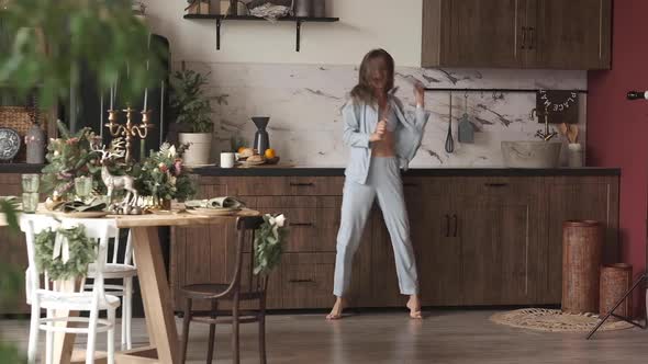 Girl in Pyjamas Having Fun in Kitchen.