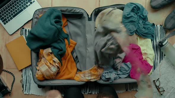 Woman Unpacks Suitcase After Travel Make Mess alt