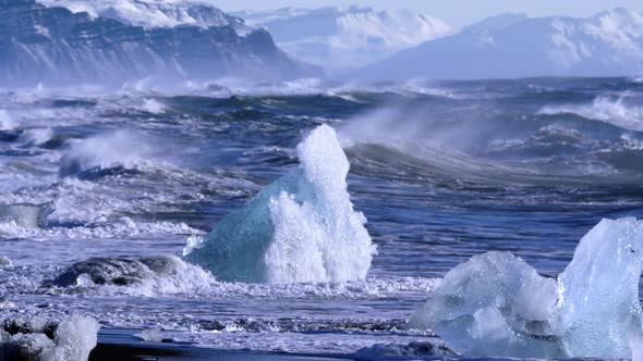 Ice From a Glacier Washing By Atlantic Ocean Waves on a Black Diamond Beach in Iceland alt