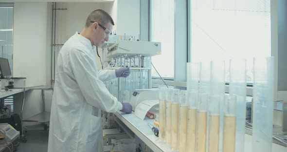 Scientist working in a pharmaceutical laboratory conducting experiments alt