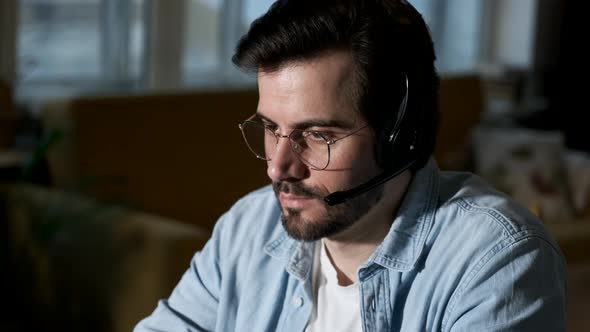 A man uses a computer works at home, businessman working on desk at home