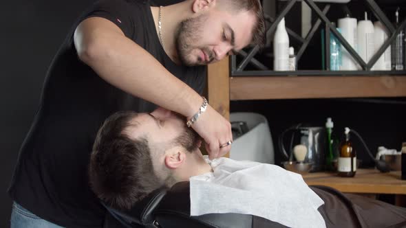 Barber Shaving Neck of Client with Razor