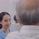 Asian nurse take care of senior man on wheelchair at the window - VideoHive Item for Sale