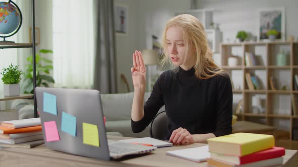 Young Beautiful Woman Learning Sign Language at Home in Living Room Using Online Lesson alt
