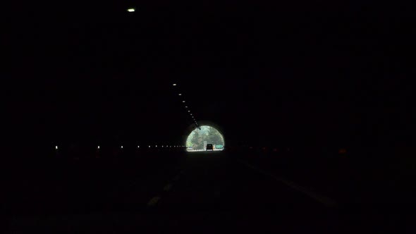 Driving pov through a tunnel on a highway freeway road. alt