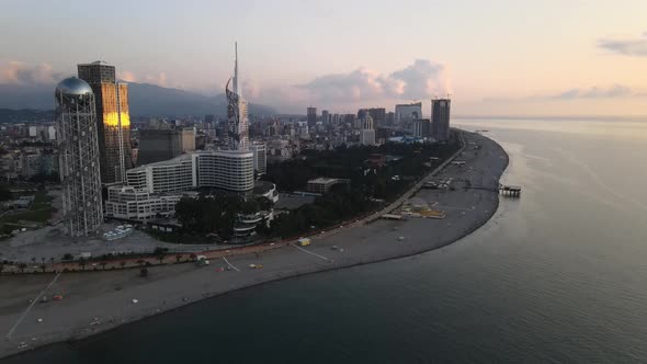 Aerial shot of alphabetic tower, skyscrapers and embankment of beautiful city of Batumi, Georgia alt