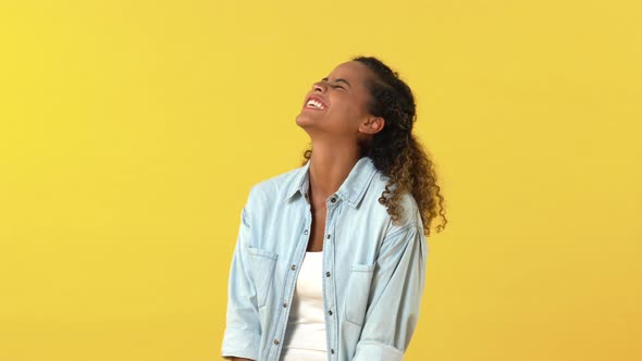Young happy African American woman laughing loud and shouting