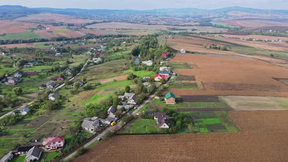 Flight over the fields behind the western Ukrainian village Aerial view.