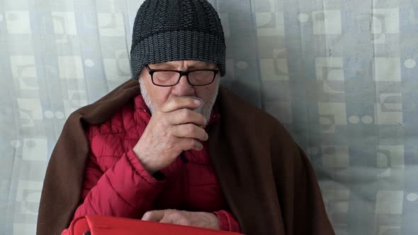Portrait of a Sad Elderly Ukrainian Refugee Drinking Tea